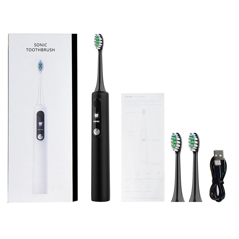 Black sonic toothbrush with packaging, brush heads, and USB cable on a white background
